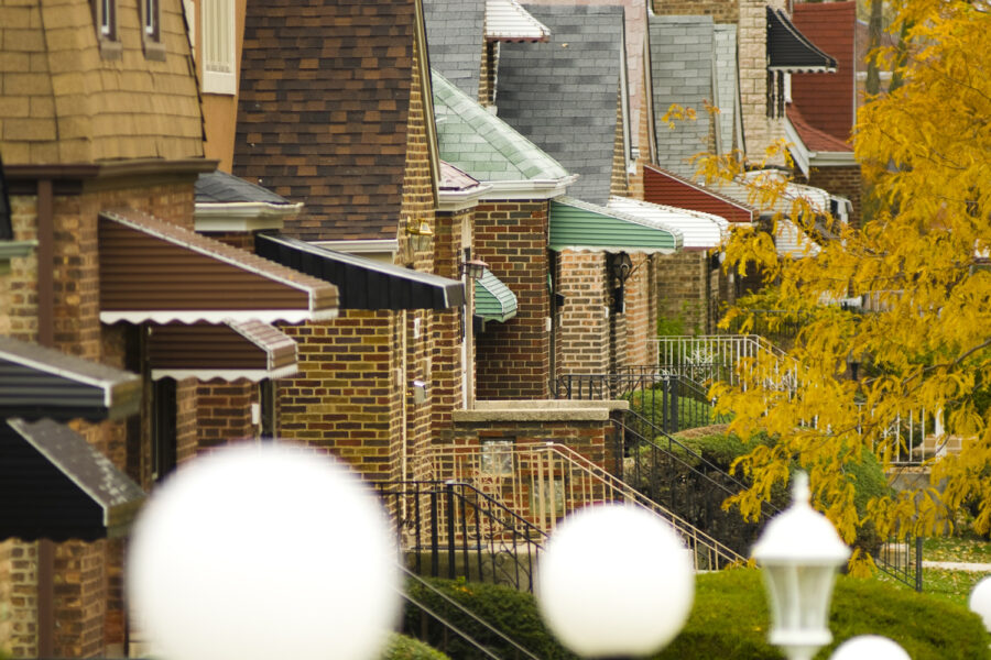 Row of brick houses with aluminum awnings over front steps